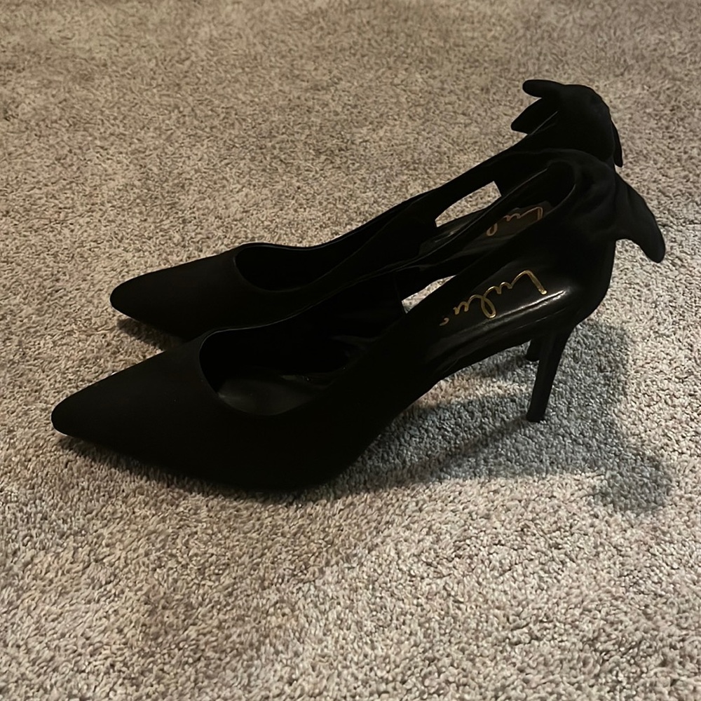 Lulus black stiletto high heels with a bow on the back